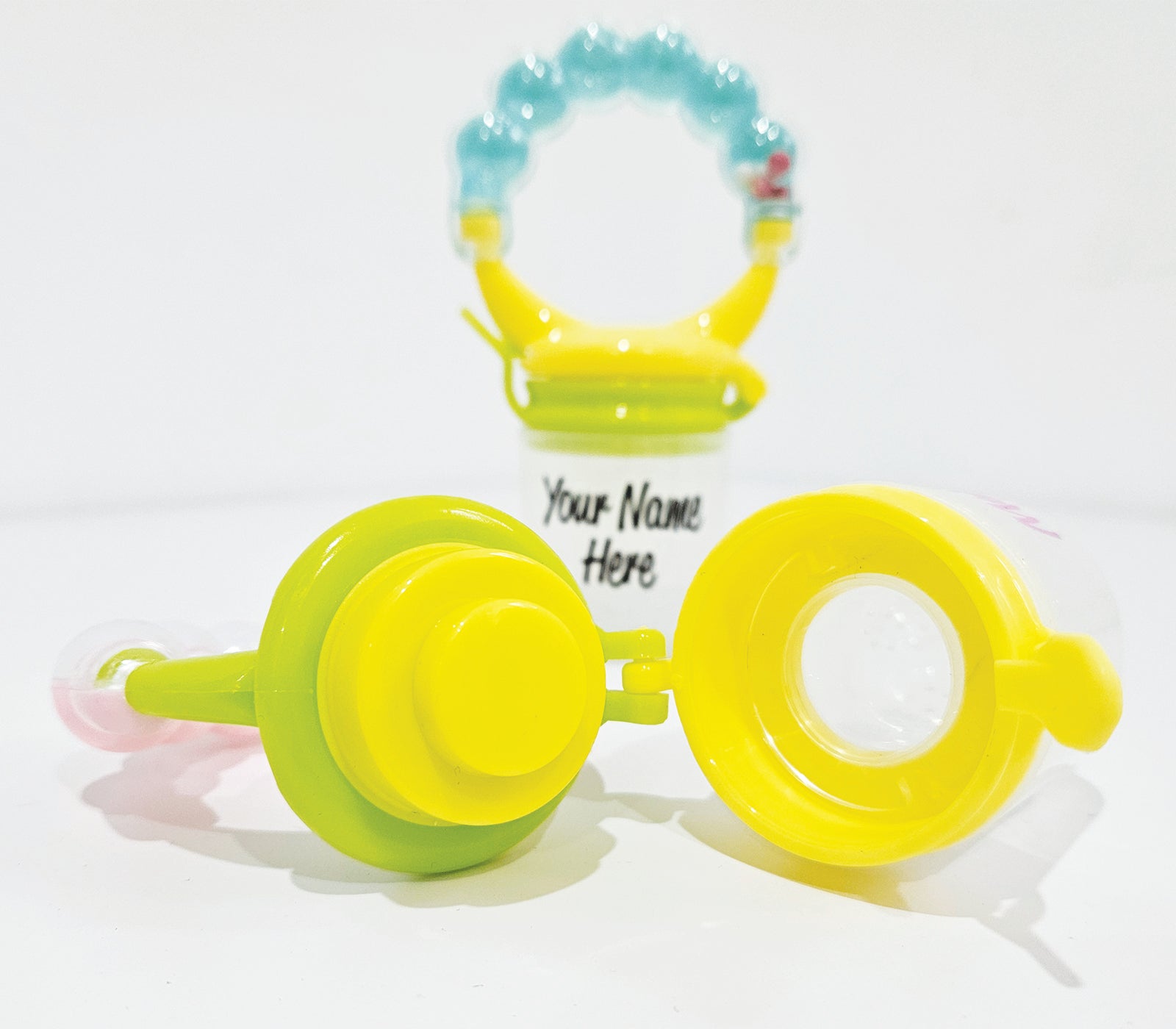 Personalised baby fruit dummy with built-in rattle, customizable with a name. Perfect for soothing and teething, this dummy combines fun and practicality. Ideal for introducing fruits safely while keeping babies entertained with the rattle sound