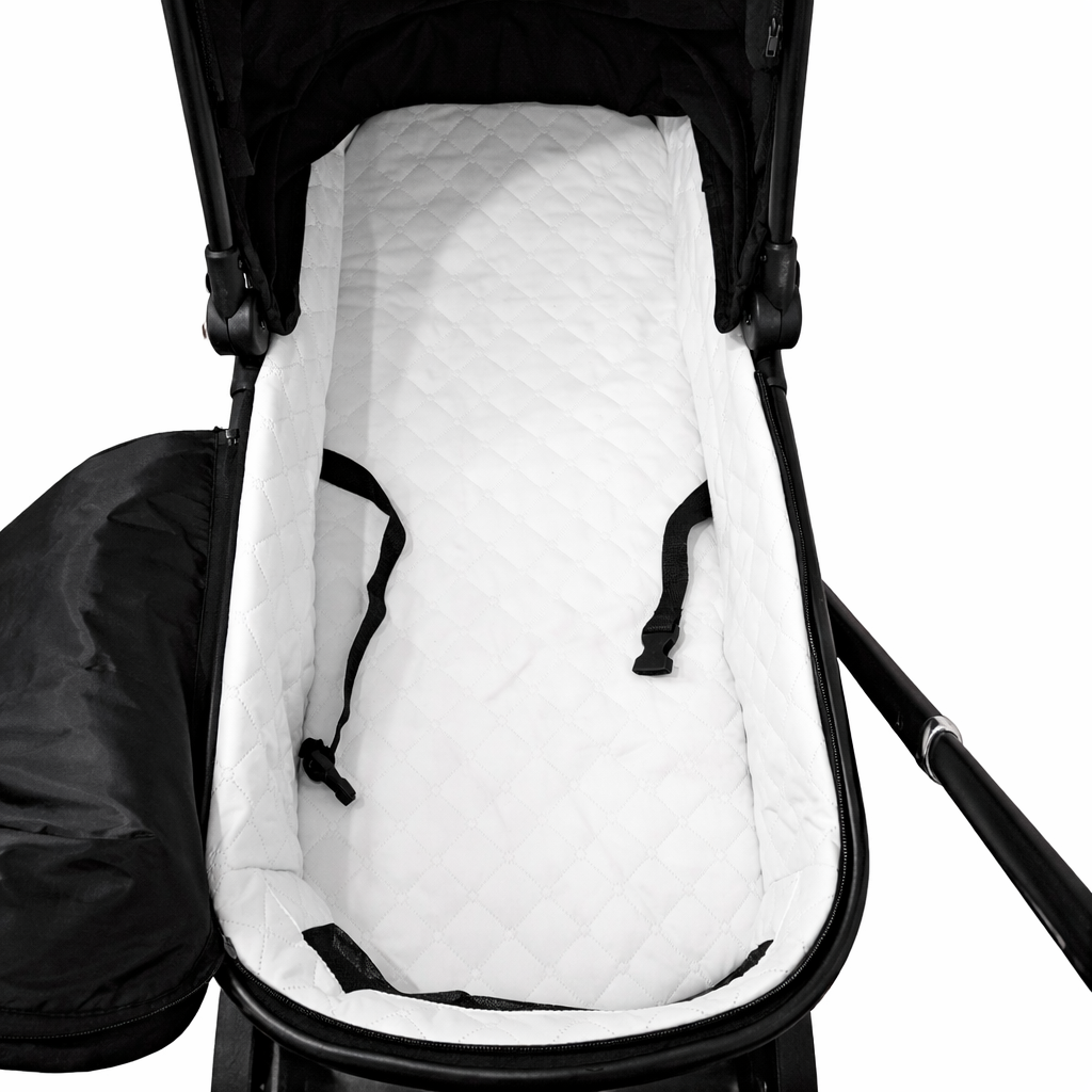 White quilted baby seat cover inside a black stroller on a white background