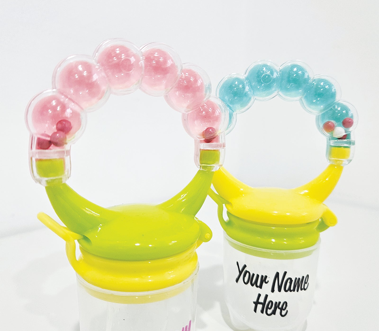 Personalised baby fruit dummy with built-in rattle, customizable with a name. Perfect for soothing and teething, this dummy combines fun and practicality. Ideal for introducing fruits safely while keeping babies entertained with the rattle sound