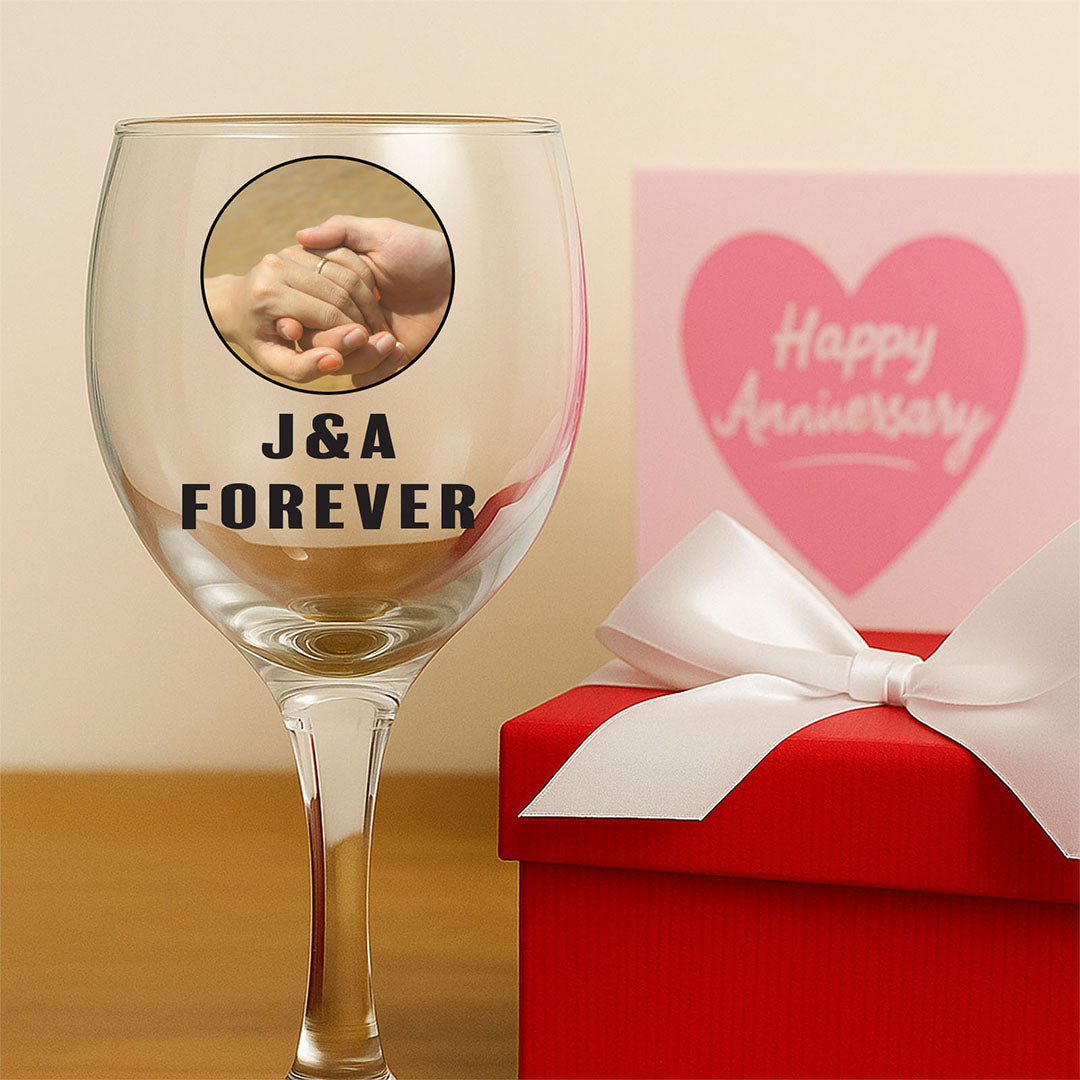 Celebrate your timeless love with our 'J&A Forever' personalized wine glass. Featuring a romantic hand-holding image, this elegant anniversary gift is perfect for toasting your everlasting bond.