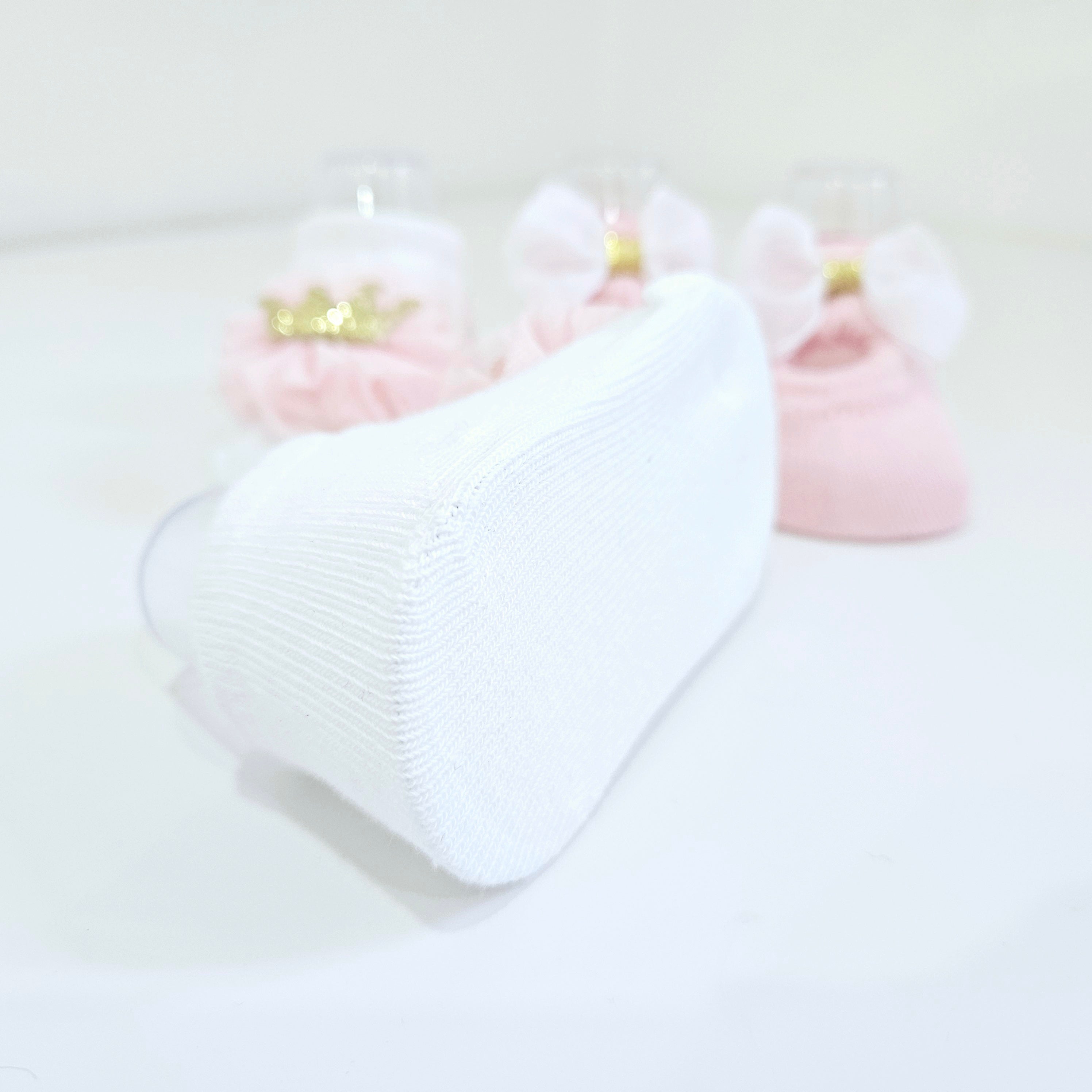 Luxury baby girl socks in pink and white, sold as a two-pack, with elegant satin bows and a sparkling crown embroidery. Ideal for special occasions and everyday comfort.