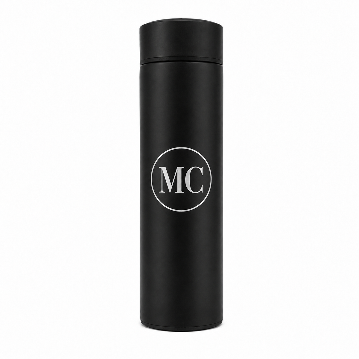 A matte black insulated travel tumbler with a matching lid, featuring a white circular monogram logo with the letters 'MC' in the center, shown on a plain white background.