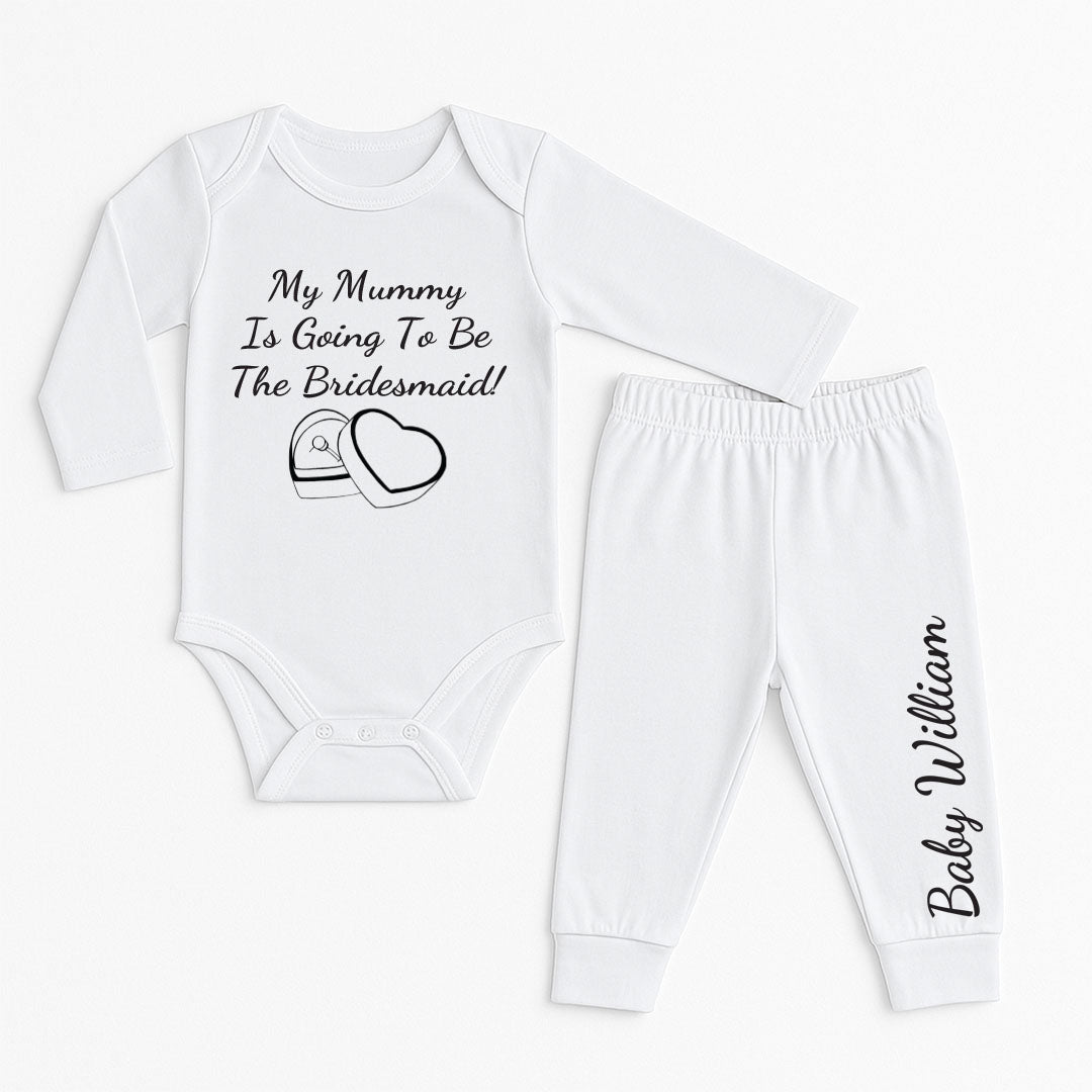 Baby outfit set with long sleeves that reads “My Mummy Is Going To Be The Bridesmaid!” featuring a heart-shaped ring box icon and the baby's name on the pants.