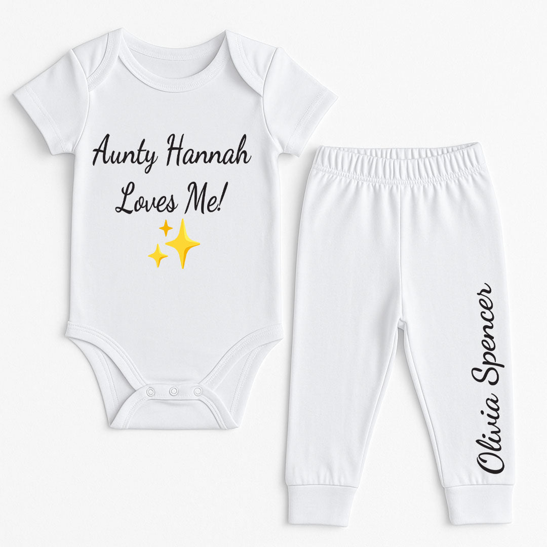 Personalized baby clothing set with “Aunty Hannah Loves Me!” on the bodysuit and the name "Olivia Spencer" on the pants, completed with sparkle emoji.