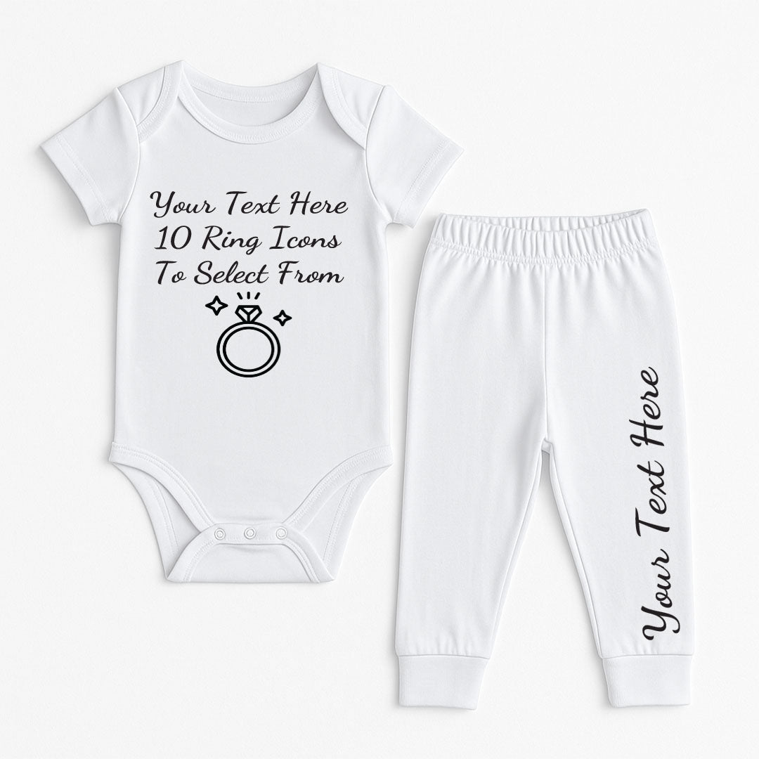 White baby outfit set with editable placeholder text and a large engagement ring icon, promoting the option to customize with different ring designs and text.