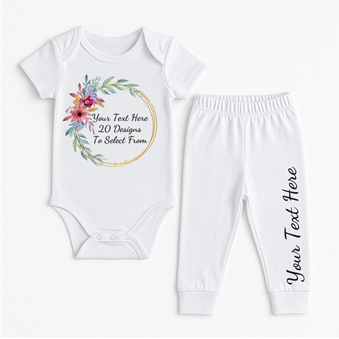 White baby vest and pants set featuring a purple and green floral circle design with placeholder text "Your Text Here – 20 Designs To Select From" and add your text on the leg.