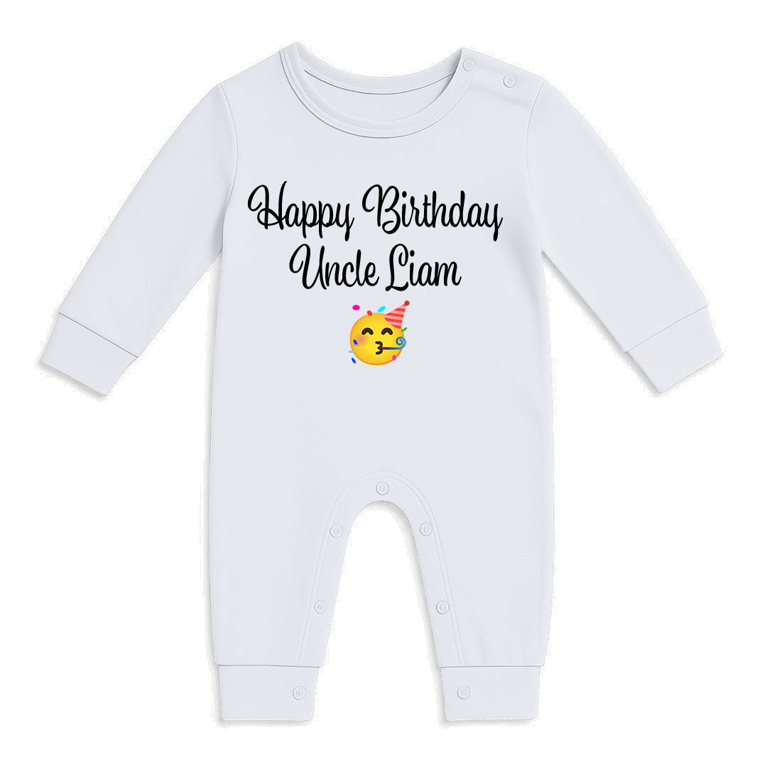 A white long-sleeve baby jumpsuit with 'Happy Birthday Uncle Liam' printed in black script on the chest, accompanied by a small yellow emoji face wearing a party hat.