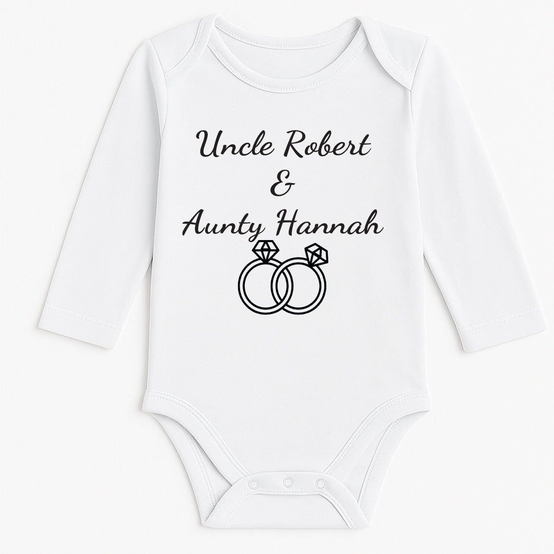 Long-sleeve white baby bodysuit with “Uncle Robert & Aunty Hannah” and two diamond ring icons, used for engagement or proposal announcements.