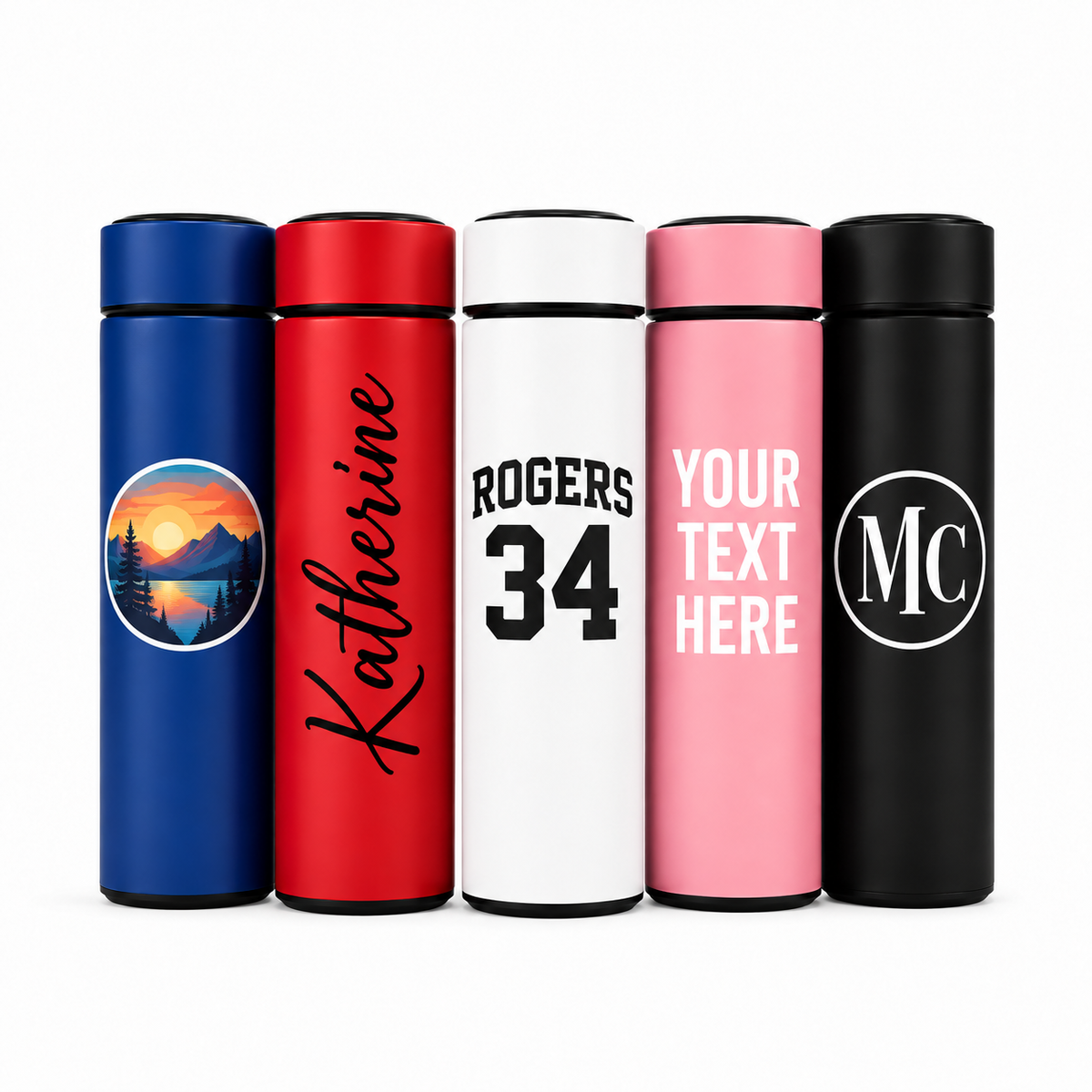 Five insulated tumblers shown side by side on a white background, each with a different color and personalization example: blue with a circular mountain sunset print, red with the name Katherine in black script, white with 'ROGERS 34' in black, pink with 'YOUR TEXT HERE' in white, and black with 'MC' in a circle.