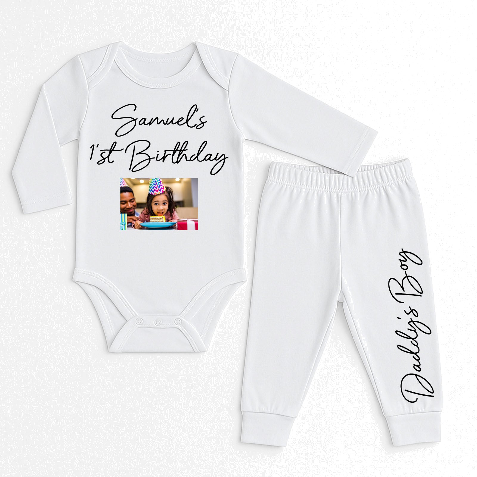 A two-piece baby outfit set consisting of a long-sleeve white bodysuit and matching jogger pants. The bodysuit features the text 'Samuel's 1st Birthday' with a customizable photo print in the center.