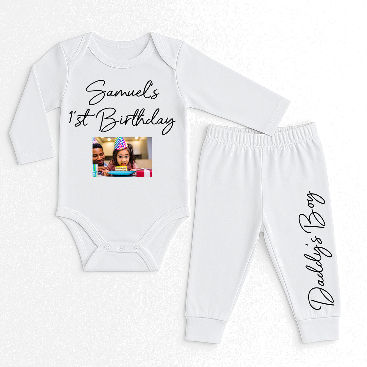 A two-piece baby outfit set consisting of a long-sleeve white bodysuit and matching jogger pants. The bodysuit features the text 'Samuel's 1st Birthday' with a customizable photo print in the center.