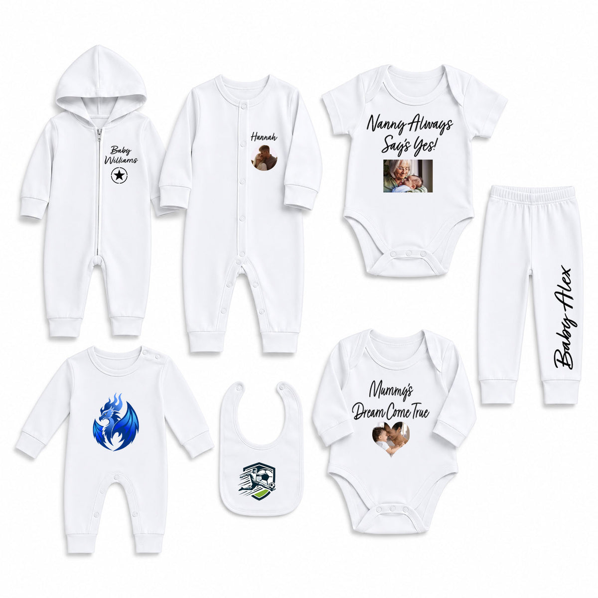 A set of white baby clothing laid out on a light gray background, including a hooded zip romper, long-sleeve bodysuit, short-sleeve bodysuit with text and photo print, matching pants, a bib, and another short-sleeve bodysuit with a blue dragon graphic. Black script text is printed on several items.