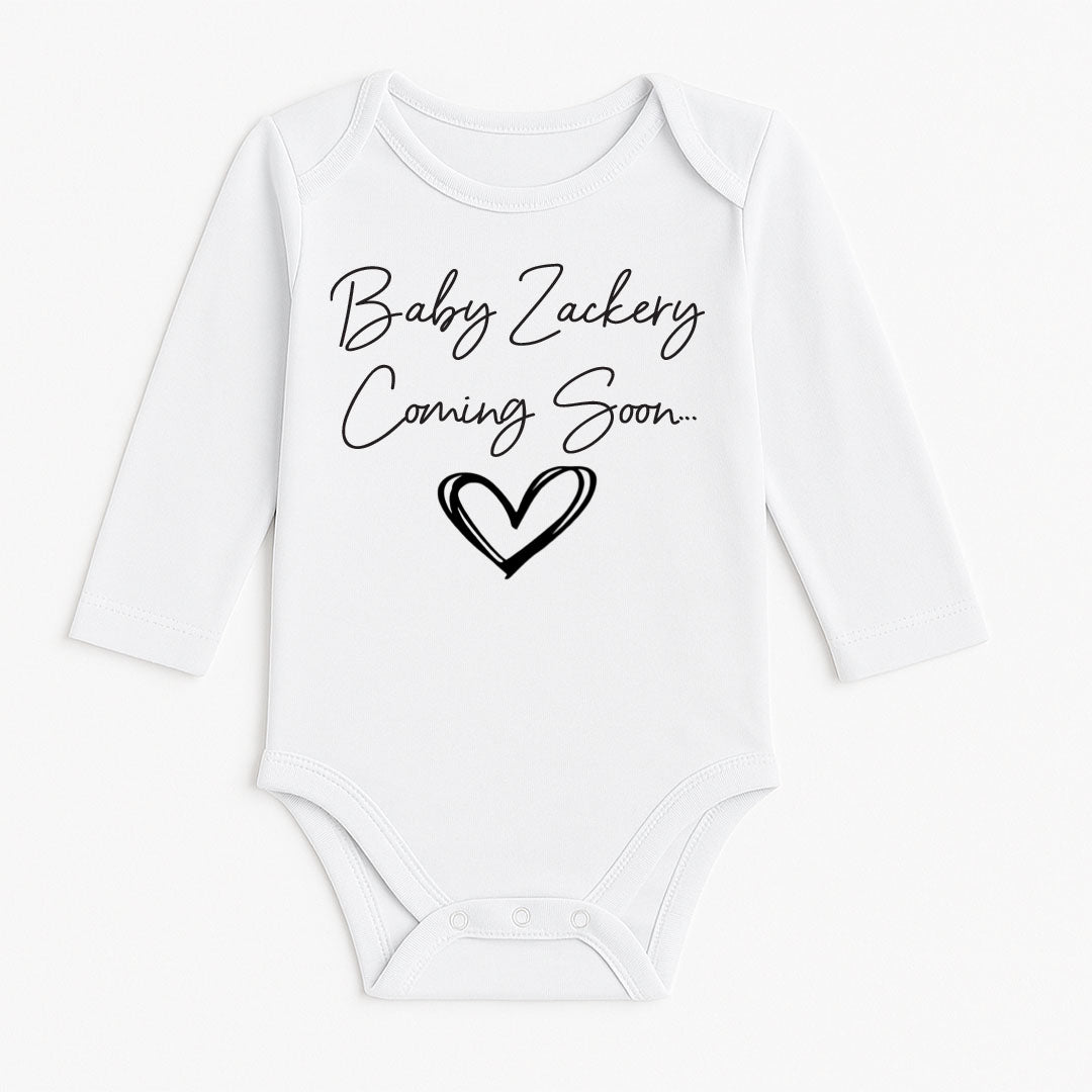 A white long-sleeve baby bodysuit with 'Baby Zackery Coming Soon.