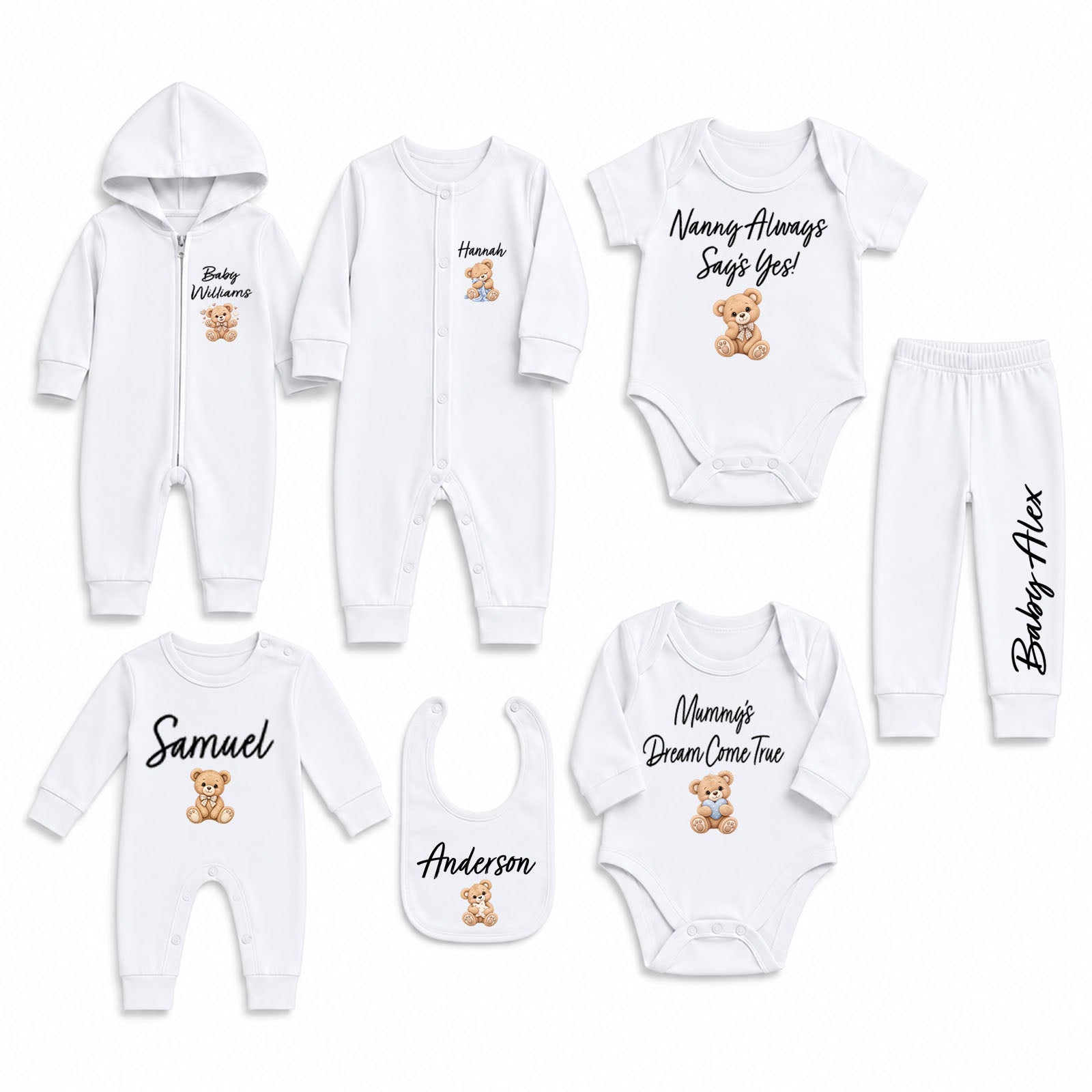 A coordinated baby clothing set laid out on a white background, including a hooded zip romper, long-sleeve bodysuit, pants, bib, and two long-sleeve bodysuits. The garments are white with black script names, teddy bear graphics, and small printed text.