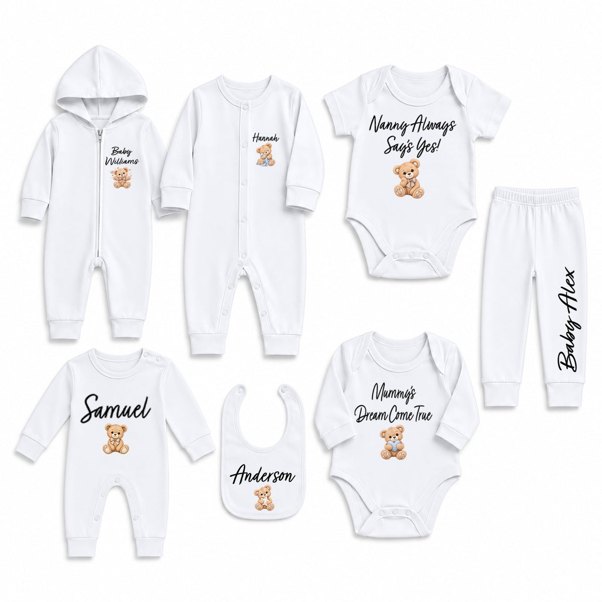 A coordinated baby clothing set laid out on a white background, including a hooded zip romper, long-sleeve bodysuit, pants, bib, and two long-sleeve bodysuits. The garments are white with black script names, teddy bear graphics, and small printed text.