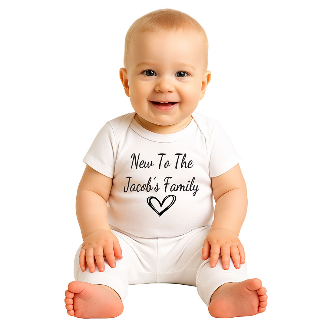 Adorable baby wearing a white onesie with the text 'New to the Jacob's Family' and a heart graphic, perfect newborn outfit for family announcements or baby showers