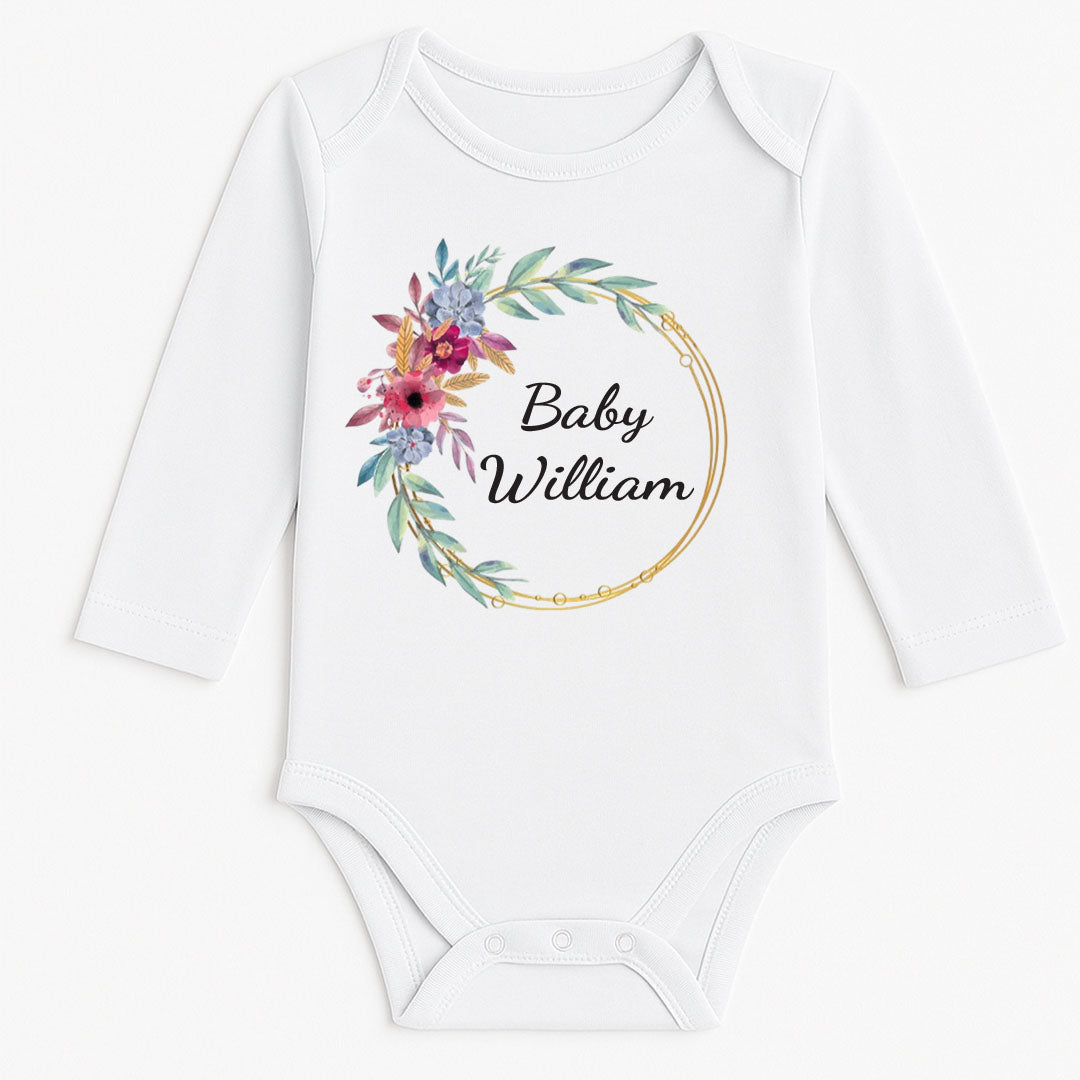 Long-sleeved white baby vest with a decorative floral ring and the name "Baby William" printed in the center.