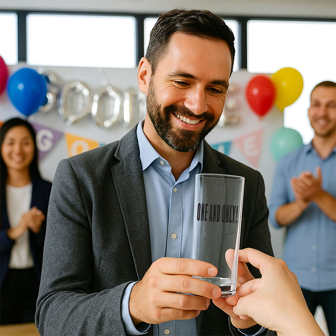 Man receives a custom clear glass with "One and Only!" text at an office leaving party. Great personalised farewell or retirement gift idea, customisable with names and messages.