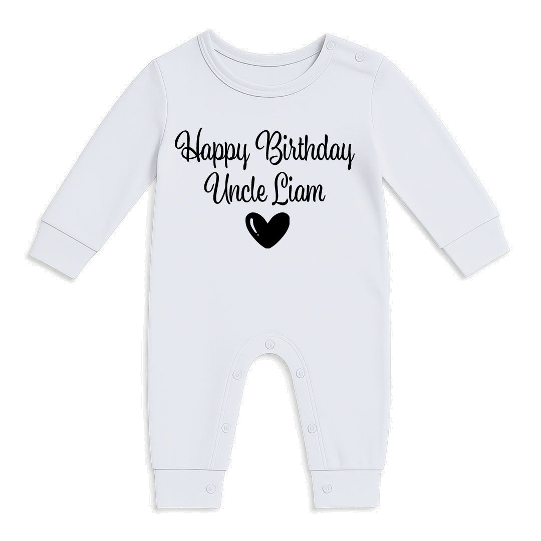 A white long-sleeve baby bodysuit with 'Happy Birthday Uncle Liam' printed in black script on the chest, accompanied by a black heart graphic, displayed on a clean white background.