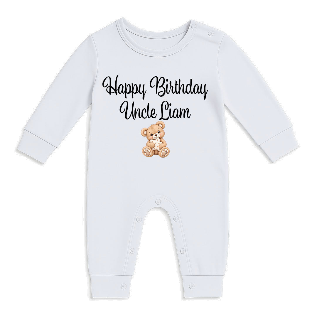 A white long-sleeve baby jumpsuit with 'Happy Birthday Uncle Liam' printed in black script above a small brown teddy bear graphic, shown on a plain white background.