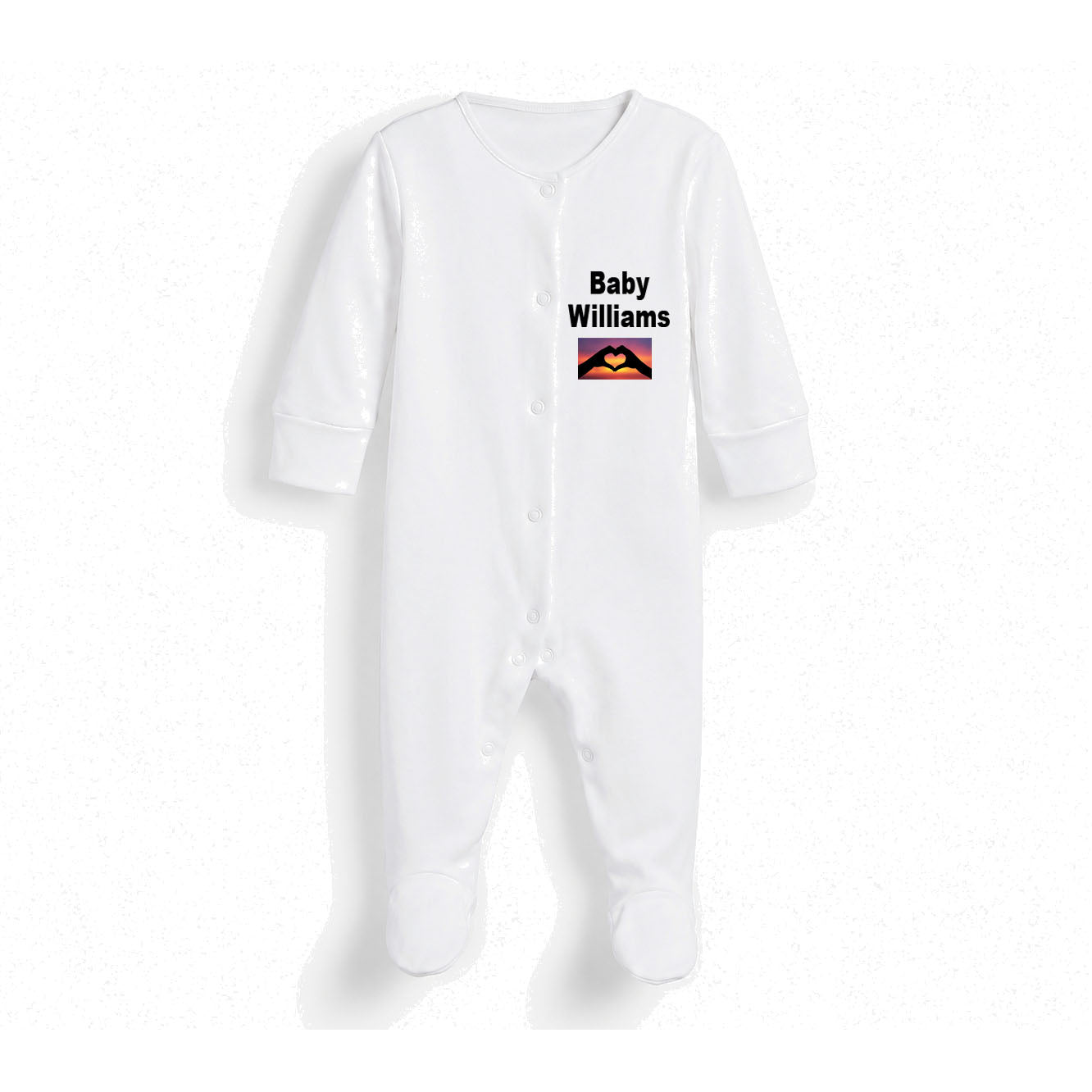 A white long-sleeve baby footed sleeper with snap closures, featuring the text 'Baby Williams' and a small colorful graphic on the chest, displayed against a white background.