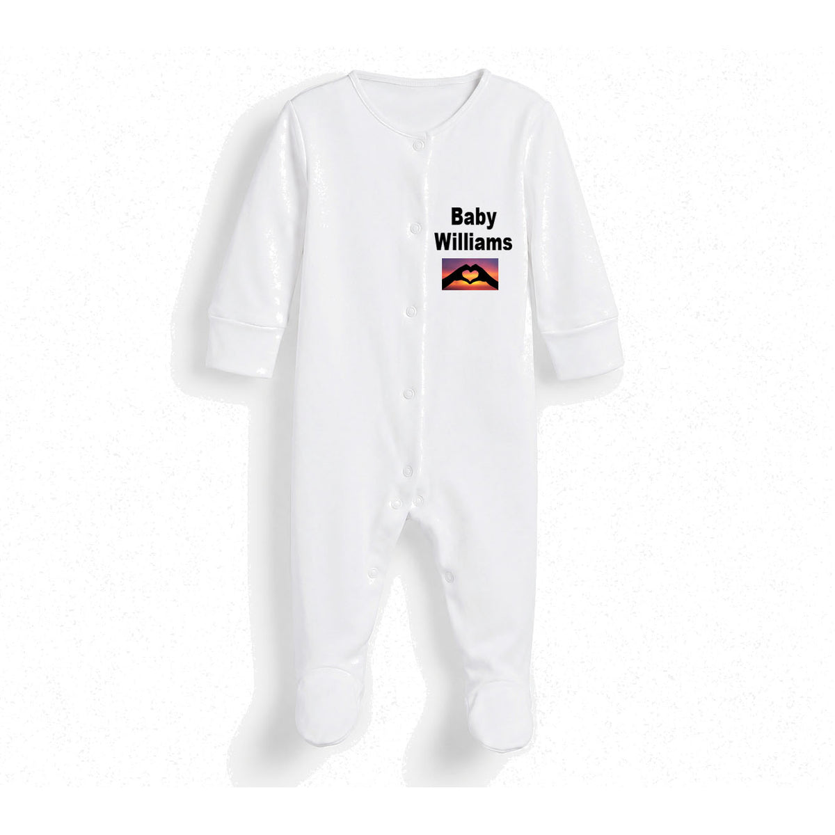 A white long-sleeve baby footed sleeper with snap closures, featuring the text 'Baby Williams' and a small colorful graphic on the chest, displayed against a white background.
