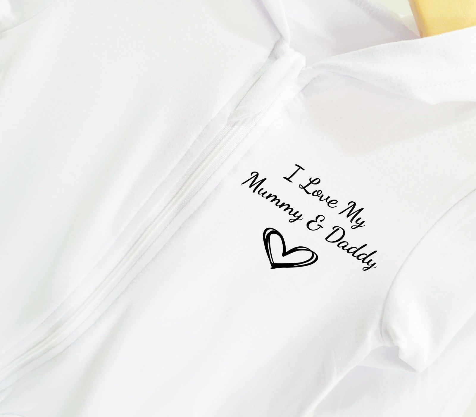 Custom name embroidered zipped hooded baby sleepsuit in white, available from newborn to 18 months, premium quality soft cotton baby clothing.