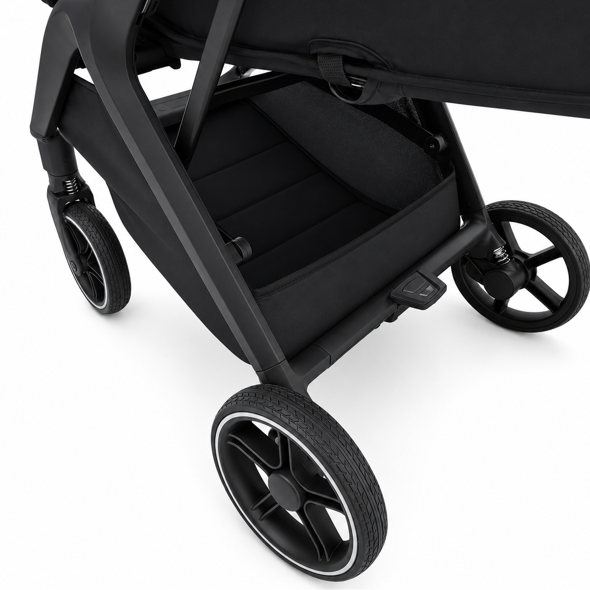 Close-up of a black stroller with a storage basket and large black wheels, photographed on a clean white background.