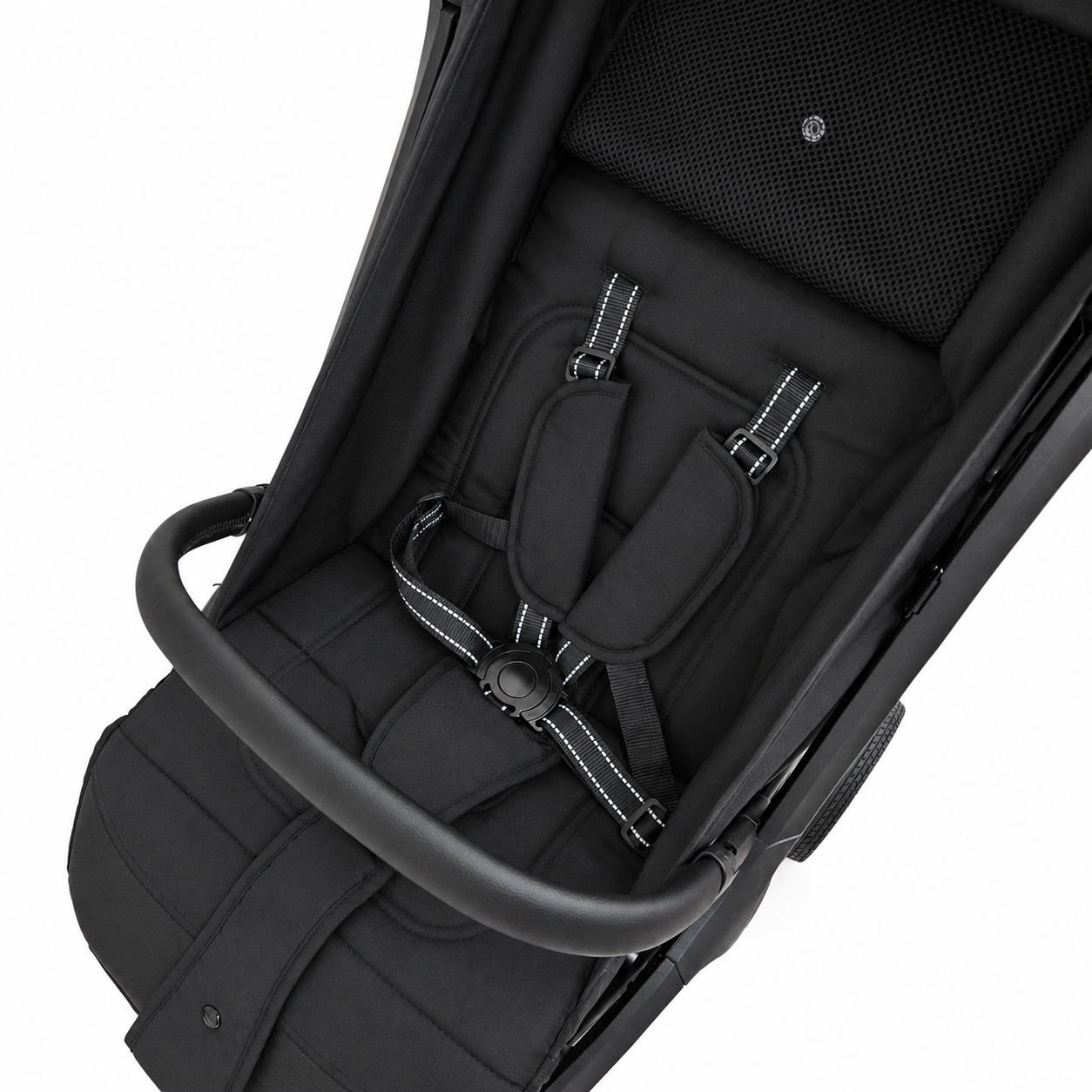 Close-up of a black baby stroller seat liner with a five-point harness, padded shoulder straps, and a black handlebar on a white background.