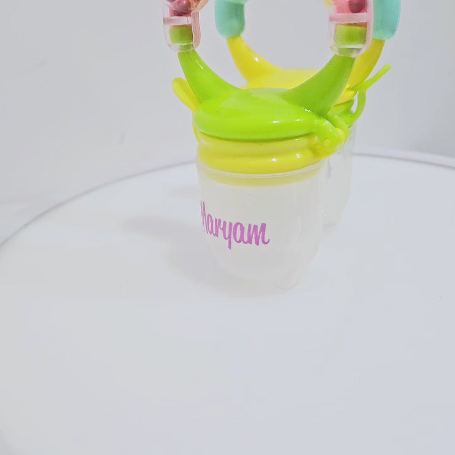 Personalised baby fruit dummy with built-in rattle, customizable with a name. Perfect for soothing and teething, this dummy combines fun and practicality. Ideal for introducing fruits safely while keeping babies entertained with the rattle sound